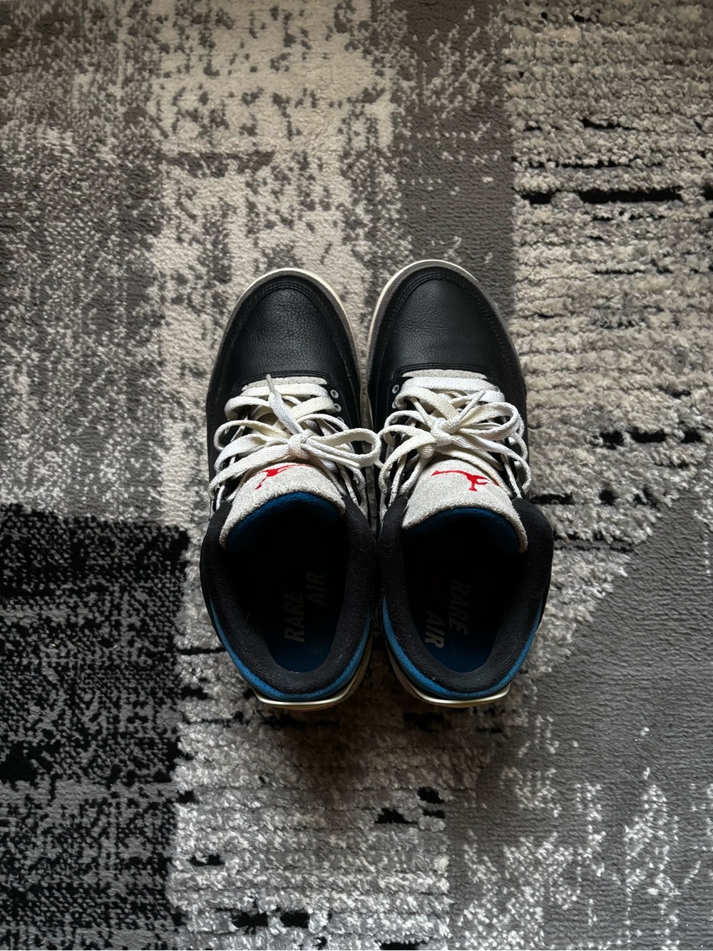 Jordan Black and White Retro High-Top Sneakers with Blue Accents